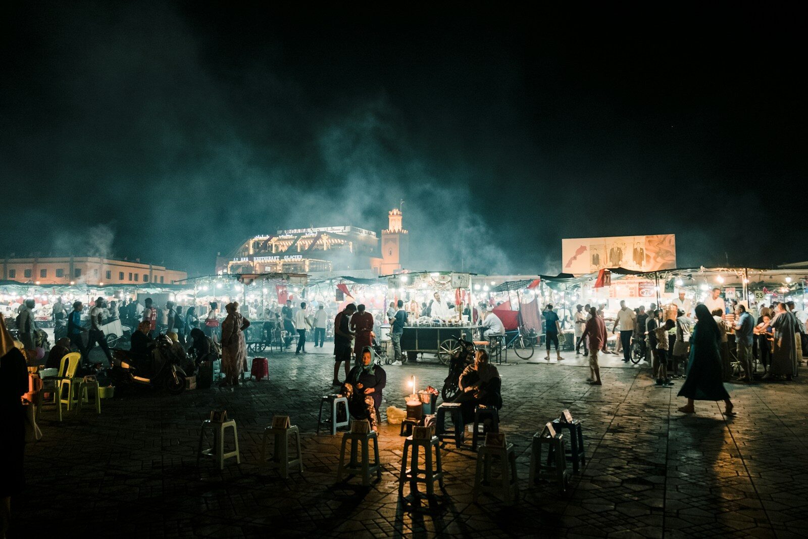 people standing on a beach during night time